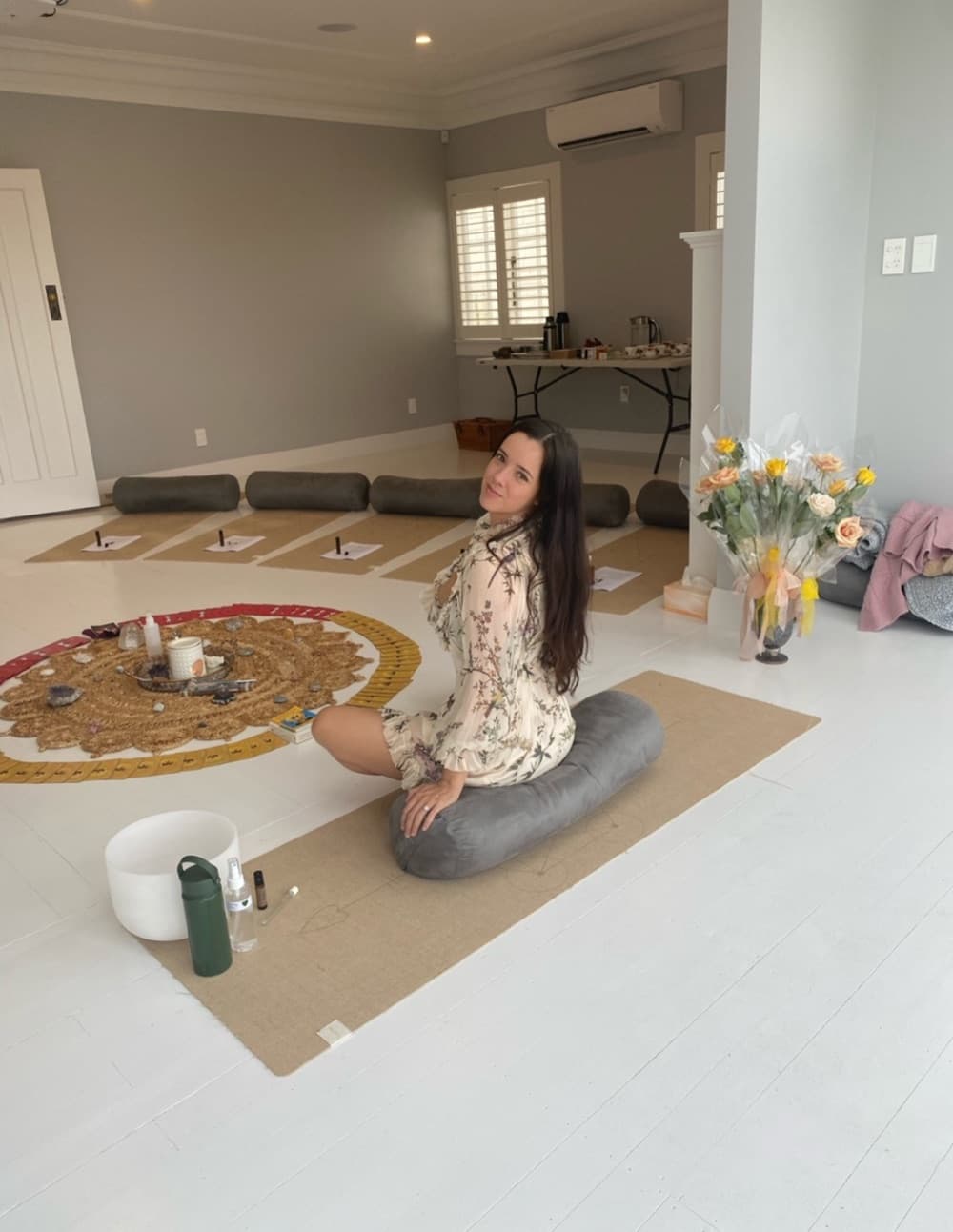 A training space with a crystal grid, mats and bolsters laid in a circle